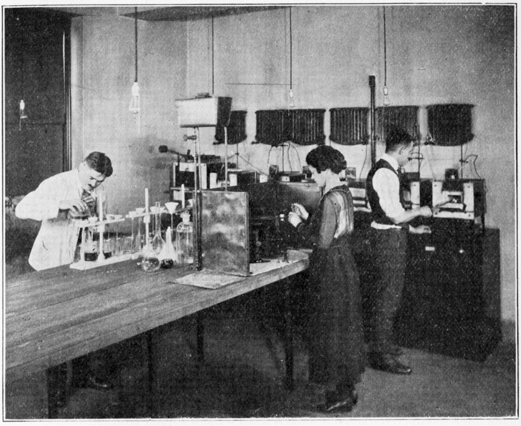 Louise Logie at work in the Chemical Department, 1920. She is conducting a test to determine the percentage of sulfur in a rubber sample.