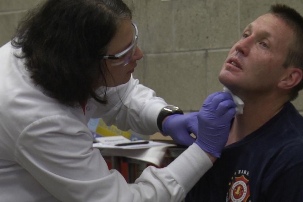 A firefighter is treated for an injury