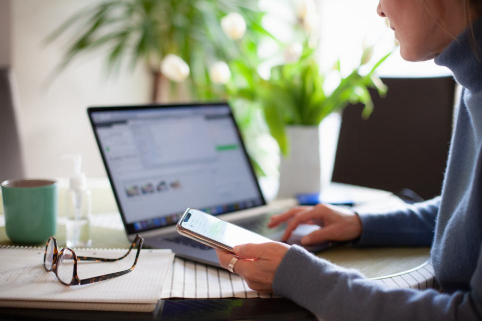  Person using laptop and mobile phone