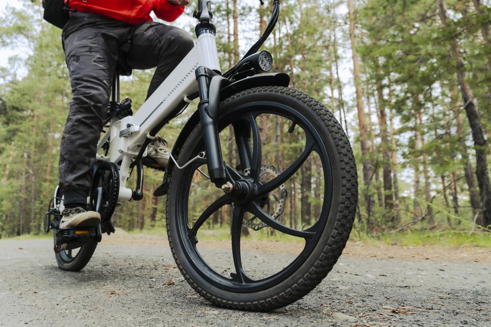 Male riding e-bike in wooded area