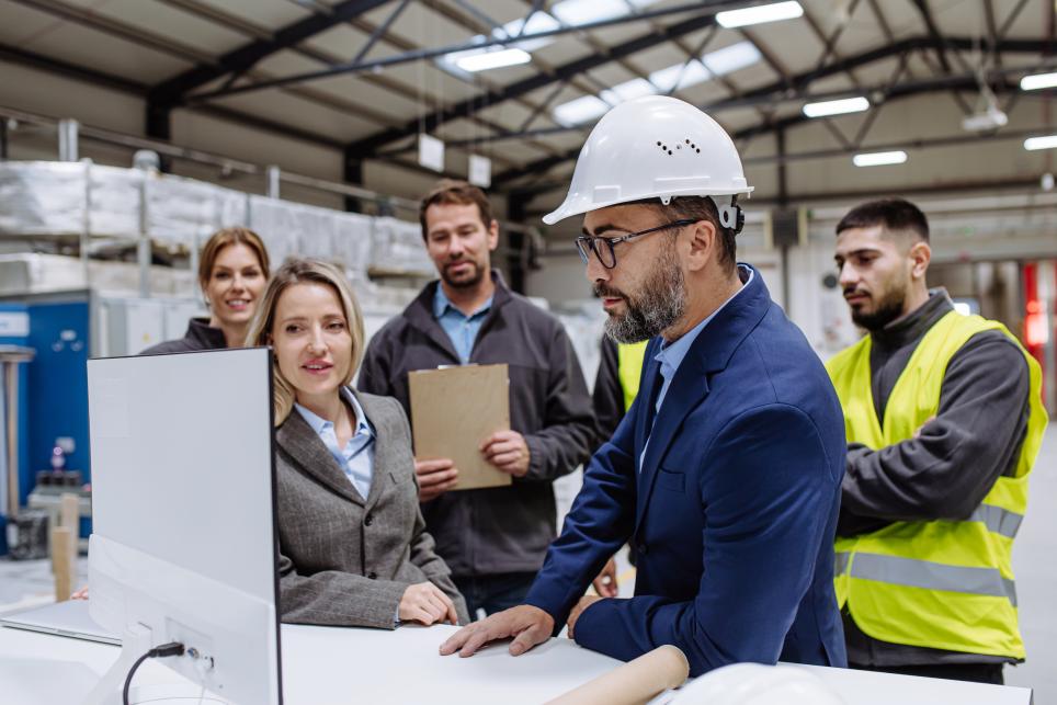 people wearing hardhats in a warehouse