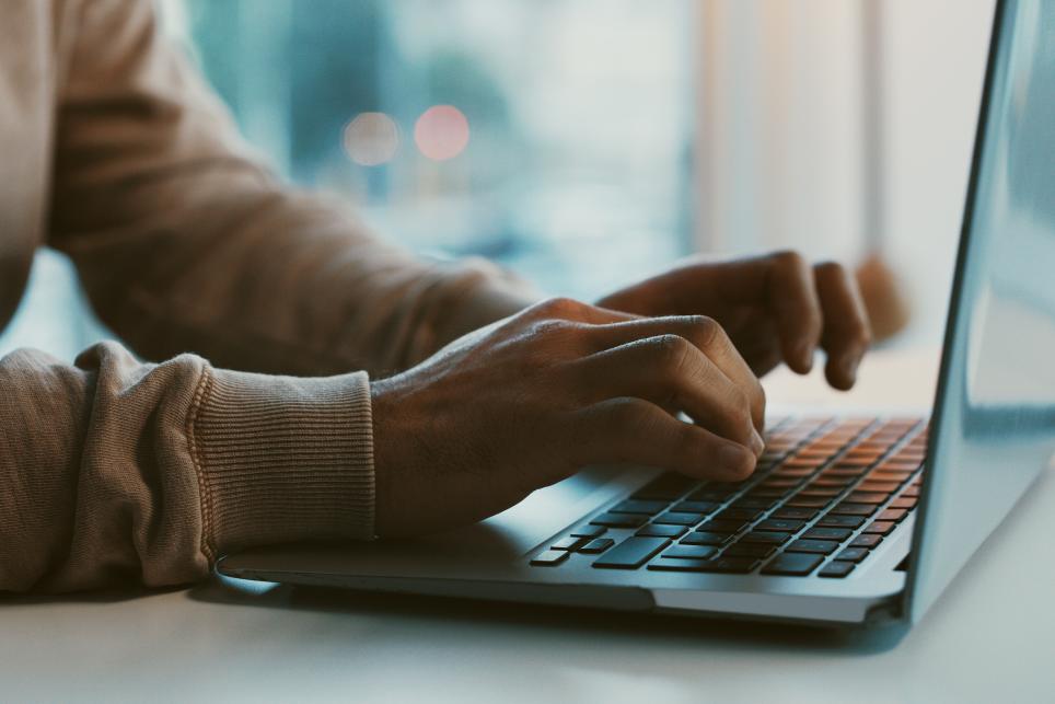 hands on a keyboard laptop