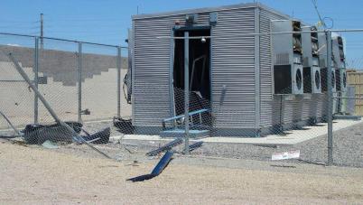 energy storage system with a broken fence and debris on the ground